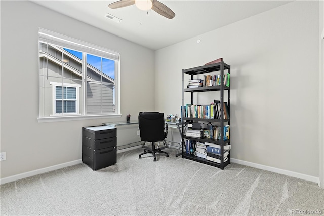 office space featuring ceiling fan and light colored carpet