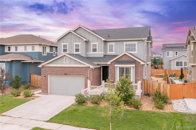 view of front facade with brick siding, board and batten siding, concrete driveway, and fence