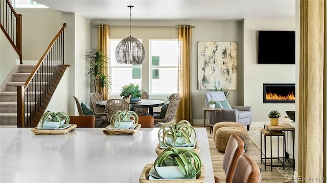 living area featuring wood-type flooring and a notable chandelier