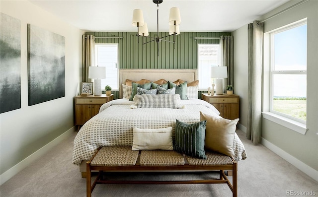 bedroom with carpet, multiple windows, and a chandelier