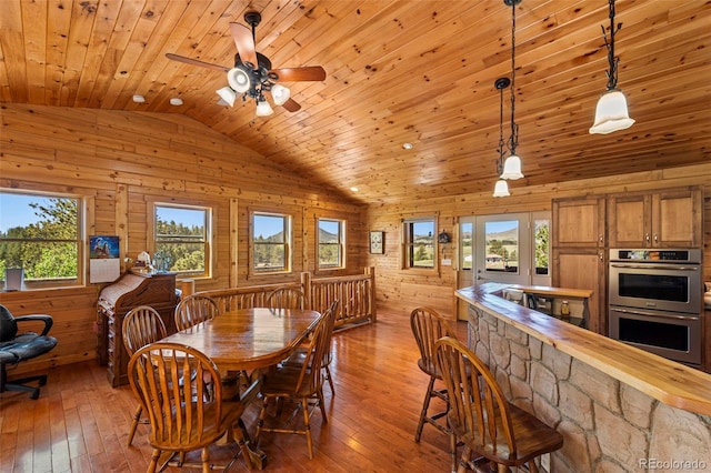 3980 County Rd 71, Guffey, CO 80820 - dining room with vaulted ceiling, wooden ceiling, hardwood / wood-style floors, wooden walls, and plenty of natural light