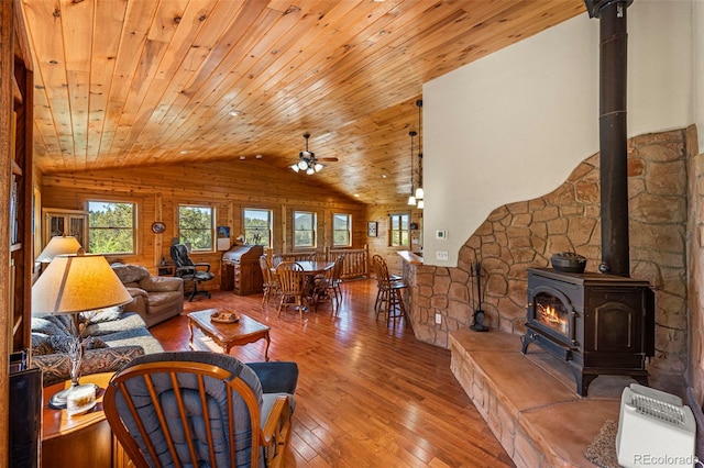 3980 County Rd 71, Guffey, CO 80820 - living room with vaulted ceiling, wood ceiling, wood-type flooring, a wood stove, and a ceiling fan