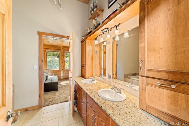 3980 County Rd 71, Guffey, CO 80820 - full bath with double vanity, a bath, tile patterned flooring, ensuite bathroom, and a high ceiling