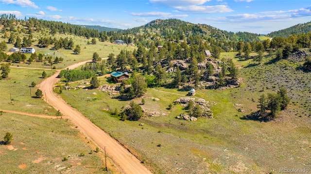 3980 County Rd 71, Guffey, CO 80820 - aerial view of property and surrounding area with mountains and a forest