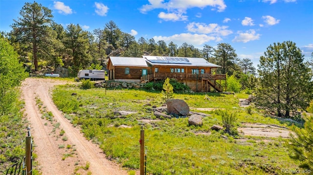 3980 County Rd 71, Guffey, CO 80820 - back of house featuring stairs, driveway, a deck, and solar panels