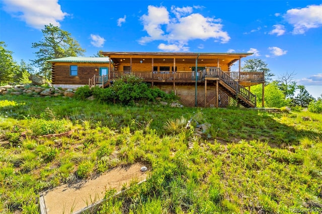 3980 County Rd 71, Guffey, CO 80820 - back of property featuring a deck, stairs, and log siding