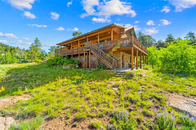 3980 County Rd 71, Guffey, CO 80820 - back of house with a wooden deck, stone siding, and stairs