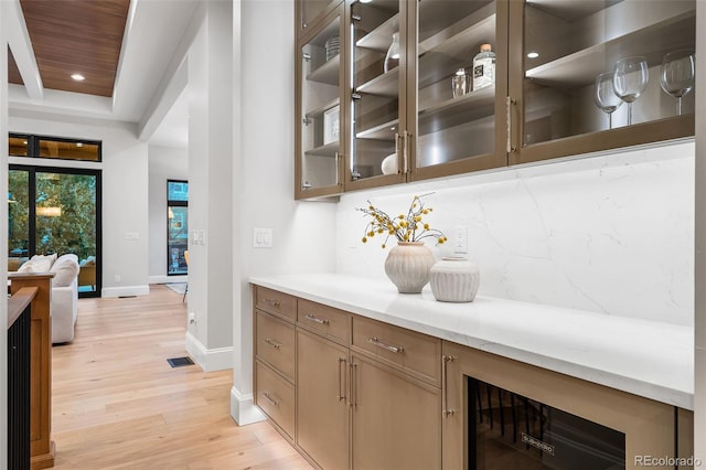 bar with decorative backsplash, light wood-type flooring, beverage cooler, and wooden ceiling