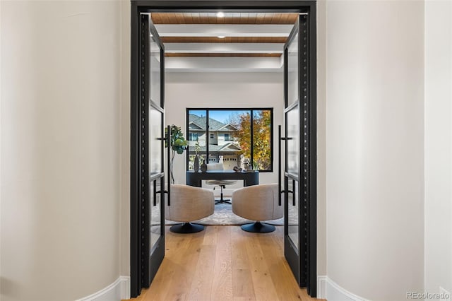 hall featuring beamed ceiling, wood-type flooring, and wood ceiling