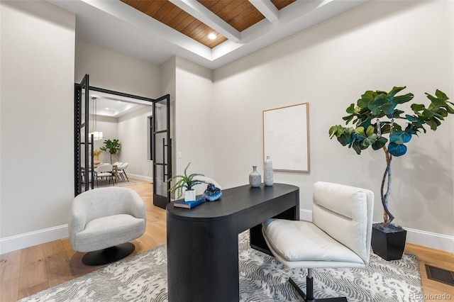 home office featuring beam ceiling, wooden ceiling, and wood-type flooring