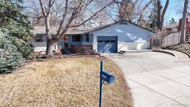 single story home with driveway, a garage, fence, and a front lawn