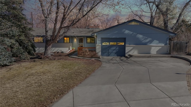 view of front facade with driveway, brick siding, a front lawn, and an attached garage