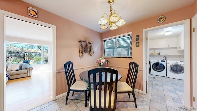 dining room with an inviting chandelier, baseboards, and separate washer and dryer