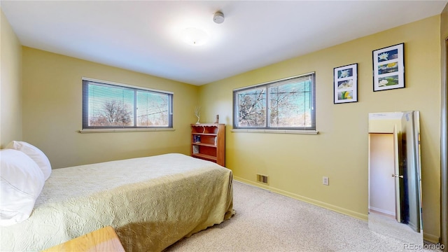 carpeted bedroom with baseboards and visible vents