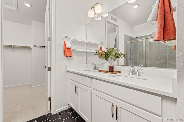 bathroom with a shower with door and vanity