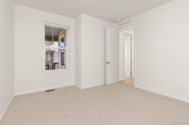 unfurnished room featuring light colored carpet