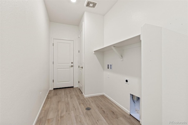 clothes washing area with light wood-type flooring, hookup for a washing machine, and electric dryer hookup