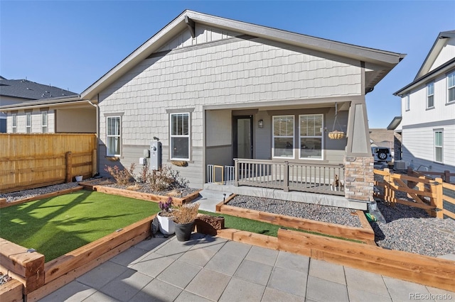 rear view of property with covered porch and central air condition unit