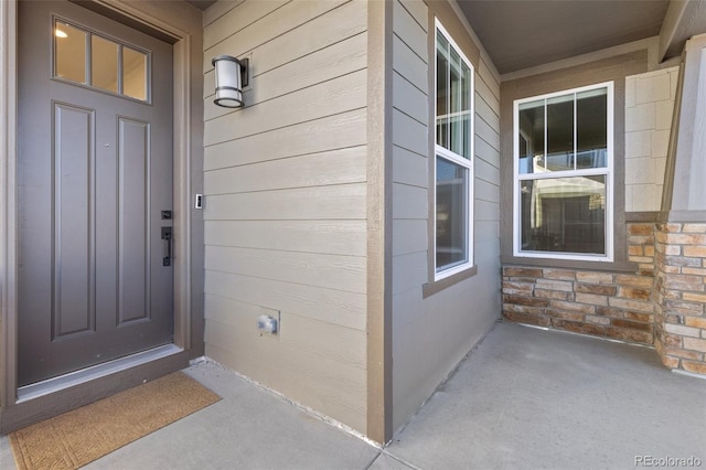 view of exterior entry with stone siding