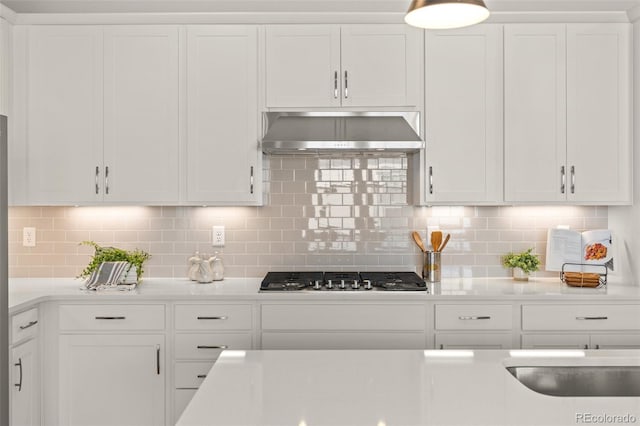 17412 W 93rd Pl, Arvada, CO 80007 - kitchen featuring ventilation hood, stainless steel gas stovetop, white cabinetry, light countertops, and tasteful backsplash