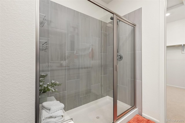 17412 W 93rd Pl, Arvada, CO 80007 - full bath with a shower stall, a walk in closet, and a textured wall