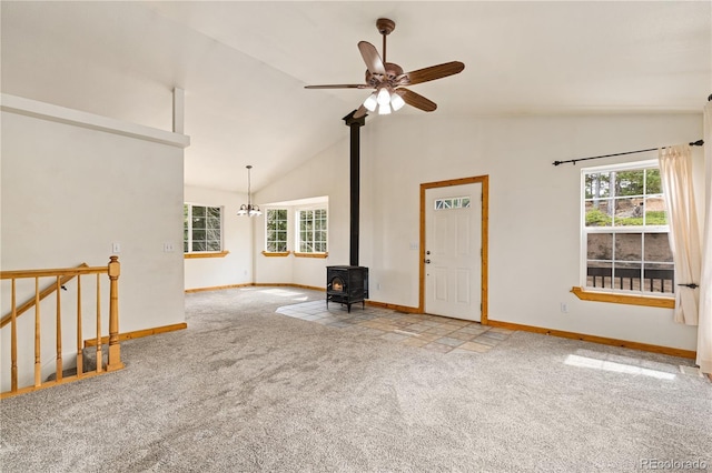 unfurnished living room with carpet flooring, healthy amount of natural light, baseboards, and high vaulted ceiling