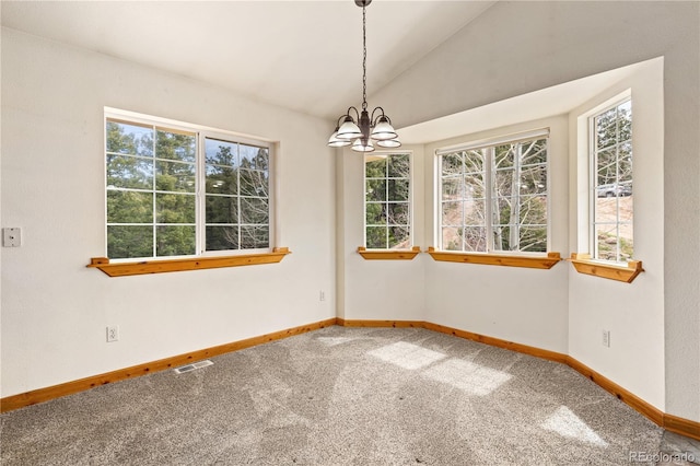 unfurnished room with carpet floors, a chandelier, vaulted ceiling, and baseboards