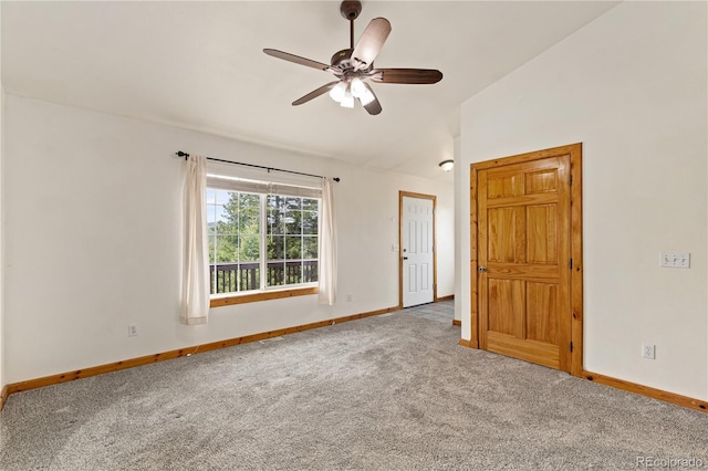 empty room with baseboards, carpet, a ceiling fan, and vaulted ceiling