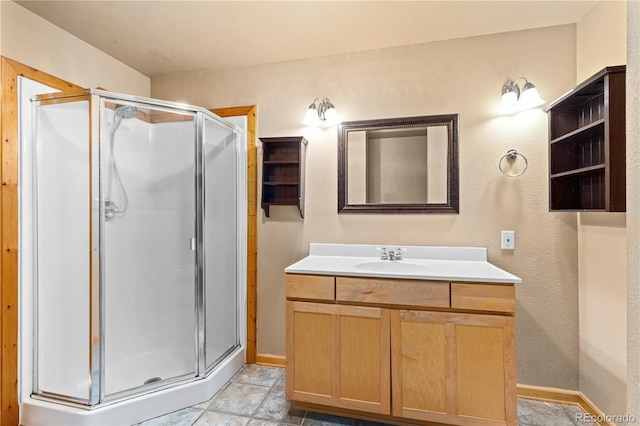 bathroom featuring a shower stall, vanity, and baseboards