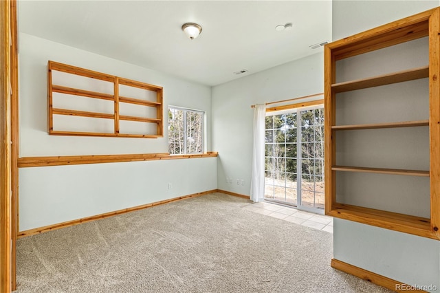 spare room with carpet flooring and baseboards