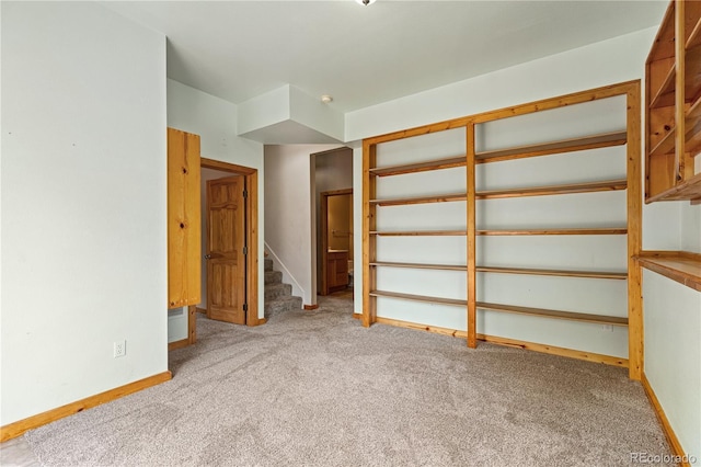 unfurnished bedroom with carpet flooring and baseboards
