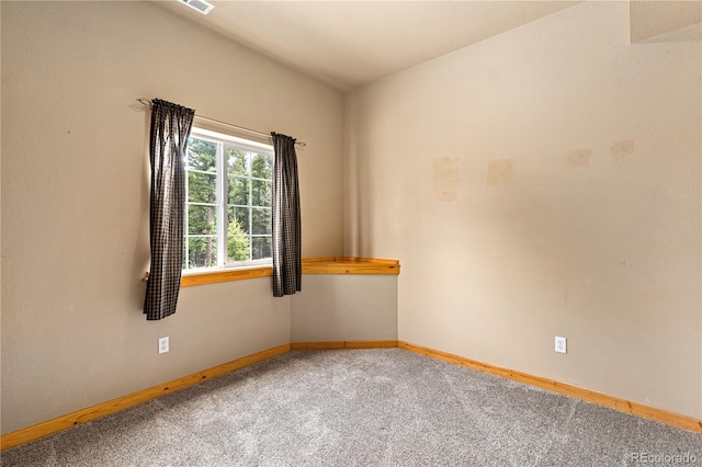 carpeted spare room with baseboards