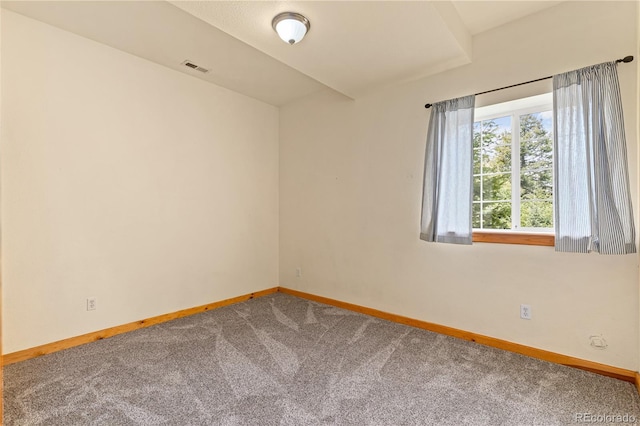 carpeted empty room with baseboards