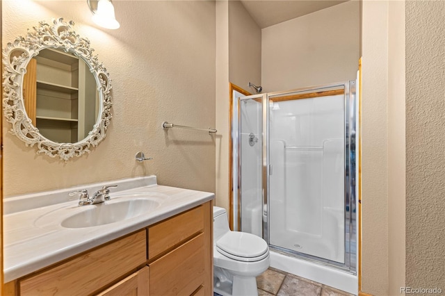 full bath with a stall shower, toilet, and vanity