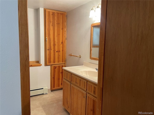 60 Pawnee Path, Lake George, CO 80827 - bathroom with a baseboard heating unit, vanity, and a textured ceiling