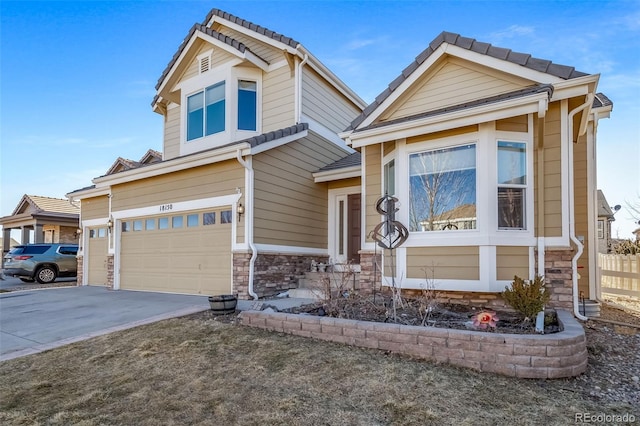 craftsman house featuring a garage, stone siding, and concrete driveway