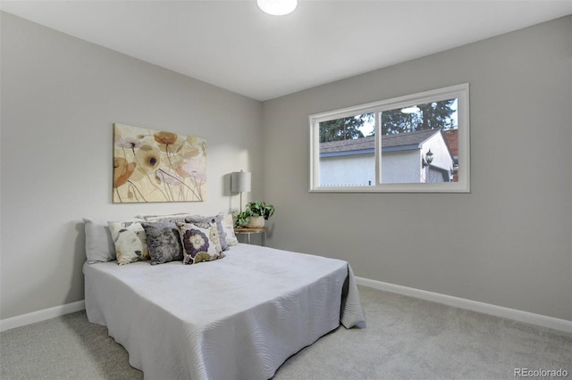 bedroom with baseboards and carpet floors