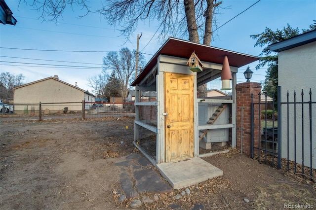 view of outbuilding featuring an outdoor structure and fence