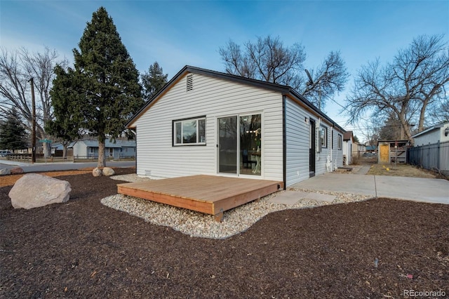 back of property with a patio, fence, and a wooden deck