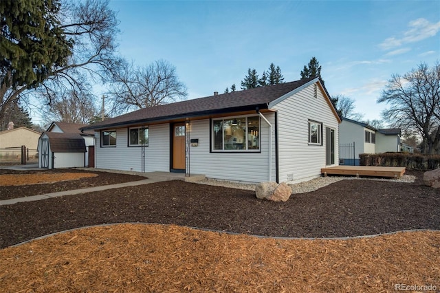 ranch-style house featuring a storage shed and an outdoor structure