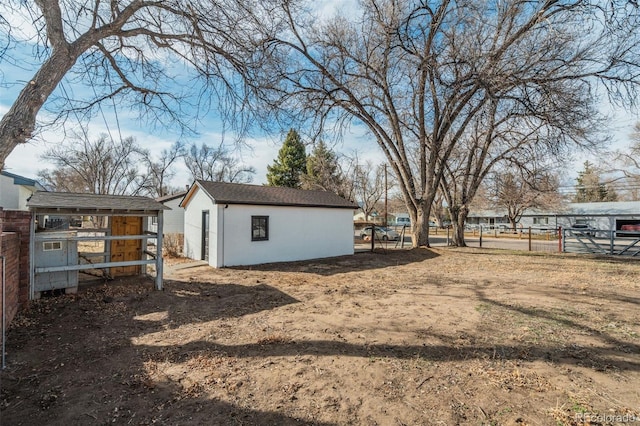 view of yard with an outdoor structure and fence