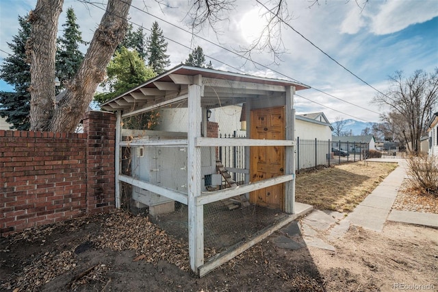 view of poultry coop featuring fence