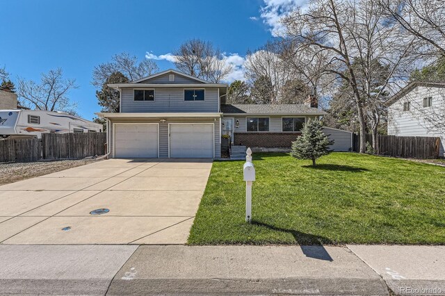 view of front of property featuring concrete driveway, an attached garage, fence, and a front lawn