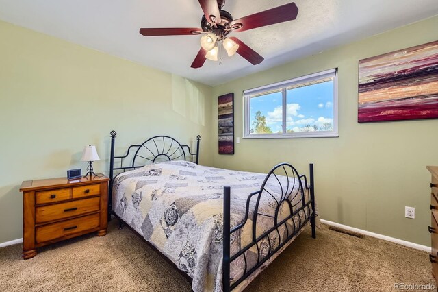 bedroom with carpet flooring, a ceiling fan, and baseboards