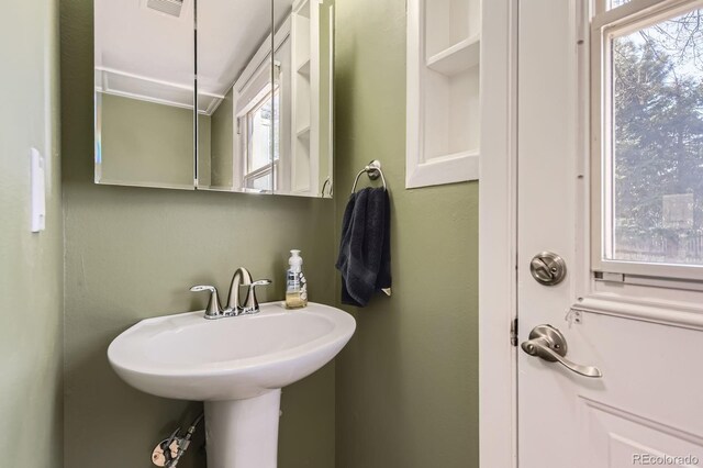 bathroom featuring a sink, a healthy amount of sunlight, and visible vents