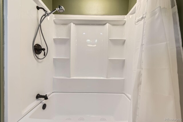 bathroom featuring shower / tub combo with curtain