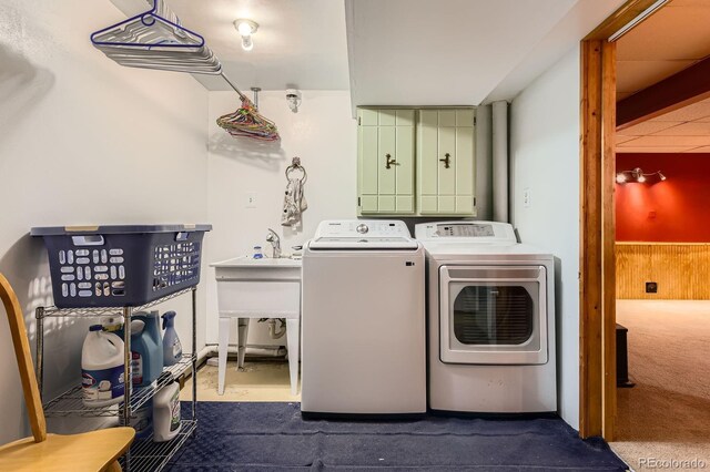 washroom featuring separate washer and dryer, laundry area, and dark carpet