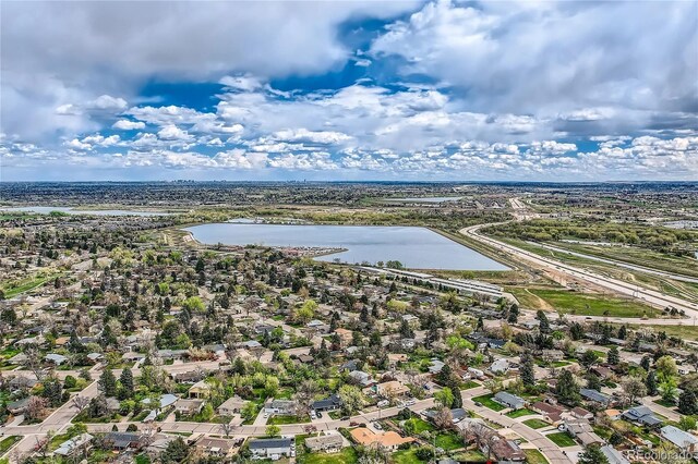 drone / aerial view with a residential view and a water view