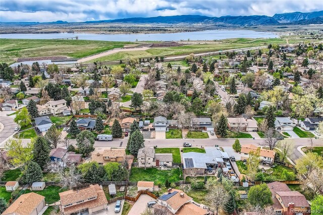 bird's eye view with a residential view and a water and mountain view