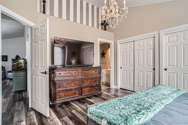3252 E 103rd Dr Unit 708, Denver, CO 80229 - bedroom featuring a towering ceiling, a chandelier, dark wood-type flooring, ensuite bathroom, and multiple closets
